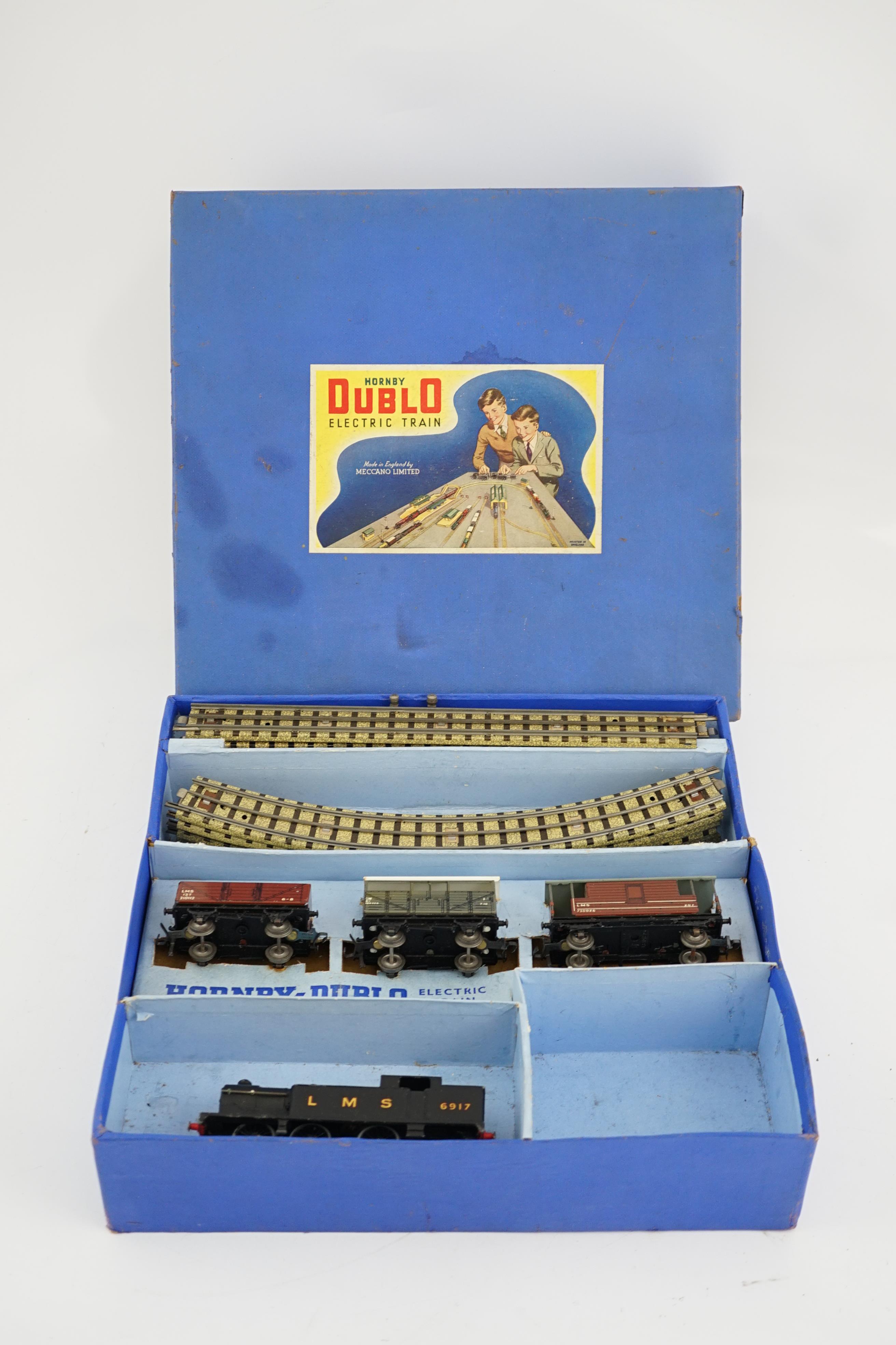 A collection of Hornby Dublo railway for 3-rail running, including; a boxed EDG7 Tank Goods Train set comprising an LMS Class N2 0-6-2 locomotive, 6917, freight wagons and track sections